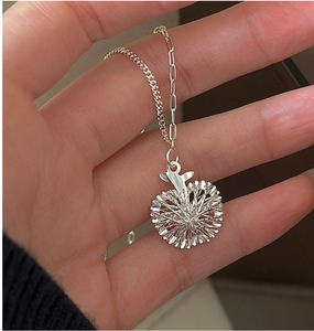 Macro shot of S925 silver apple pendant with radial texture and stylish mixed chain detail