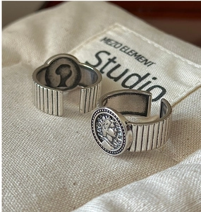 Close-up of vintage S925 silver coin rings with adjustable vertical stripe bands