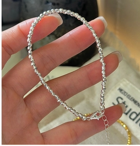 Macro shot of faceted silver beads bracelet with adjustable lobster clasp detail