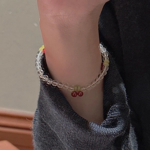 Handmade cherry beaded bracelet with red fruit charms and green leaf accents