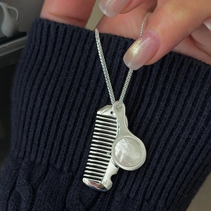 S925 sterling silver sweater chain featuring vintage mirror and comb pendants on knitwear