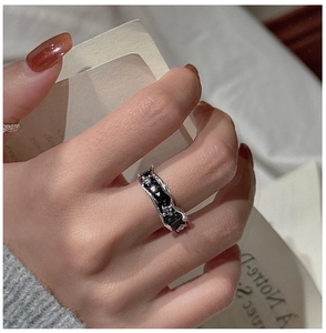 Detail of S925 silver irregular ring with black drip oil finish and subtle crystals