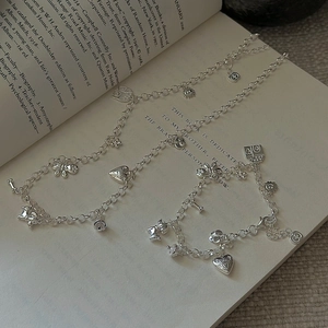 Retro S925 silver necklace and bracelet set with cute heart and bear charms on a book