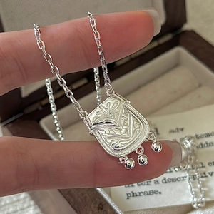 S925 sterling silver handbag pendant necklace with intricate floral relief and bell tassels