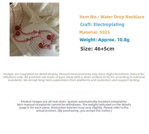 Detailed view of the S925 silver water drop pendant on a woven red and white cord necklace