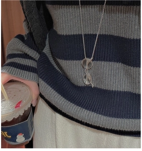 Vue détaillée d'un pendentif lunettes en argent S925 sur une longue chaîne pull