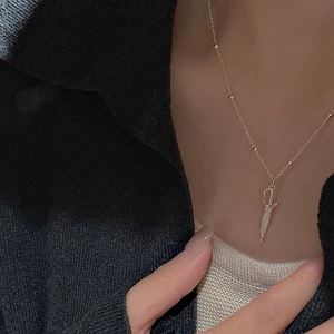 Detail of S925 silver umbrella pendant on a delicate beaded chain necklace for women