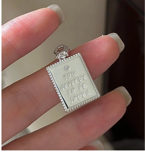 Macro view of S925 silver rectangle pendant with 'you deserve to be loved' engraving
