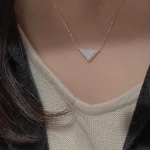Sparkling S925 silver triangle pendant necklace with pavé zircon stones on a model