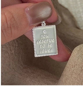 Macro view of S925 silver rectangle pendant with you deserve to be loved engraving