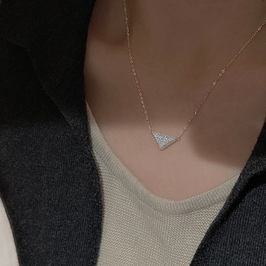 Close-up of rose gold S925 silver necklace with micro-pave zircon triangle pendant
