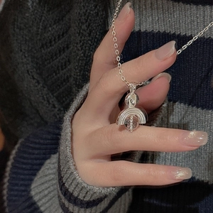 Macro shot of S925 sterling silver necklace with a unique crystal pendant on hand