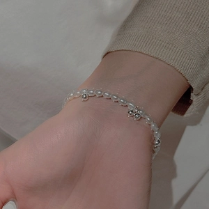 Close-up of s925 silver beaded bracelet with freshwater pearls and silver ball charms