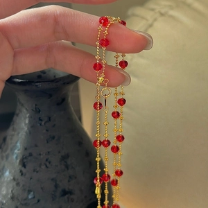 Minimalist S925 silver necklace featuring red crystal beads and golden ball chain