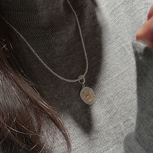 Detailed view of vintage S925 silver rope chain with gold horse relief oval pendant