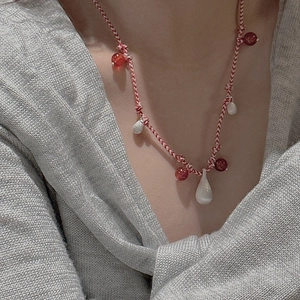 Minimalist S925 sterling silver red cord necklace with teardrop pendant worn by a model