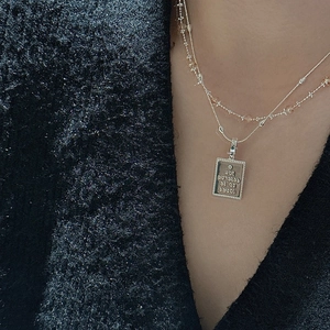 Layered S925 sterling silver necklace with engraved rectangular pendant on model