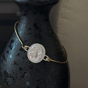 S925 sterling silver bangle with a vintage gold and silver coin charm featuring a portrait