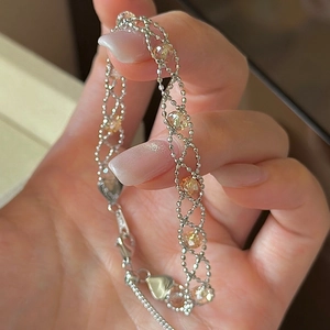 Elegant s925 silver beaded lace bracelet with orange faceted crystals shown on hand