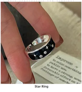 Detailed view of S925 sterling silver star ring with black enamel and silver engravings