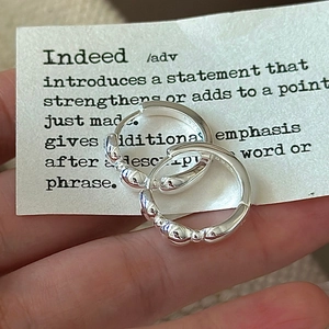 Handheld S925 sterling silver hoop earrings with irregular beaded texture and smooth finish