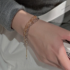 Detailed macro view of an S925 silver lace-style woven mesh bracelet in gold and silver