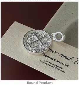 Détail du pendentif croix en argent S925 avec texture martelée et fini vintage