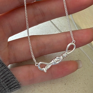Minimalist S925 sterling silver infinity knot necklace worn on hand for women