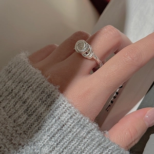 Minimalist S925 sterling silver knotted ring shown on finger with cozy grey sweater