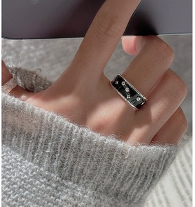 Detailed shot of wide S925 silver ring with black enamel inlay and star motif