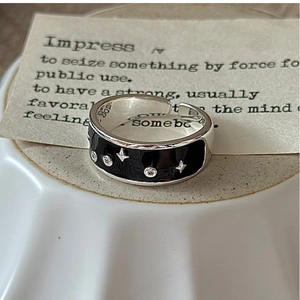 Macro detail of S925 silver ring featuring black enamel stars and internal engraving