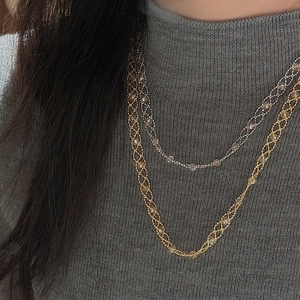 Detail of layered S925 silver lace necklaces with gold woven mesh and crystal accents