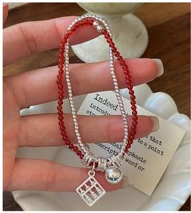 Detail of S925 silver double-layer bracelet with red agate beads and abacus pendant