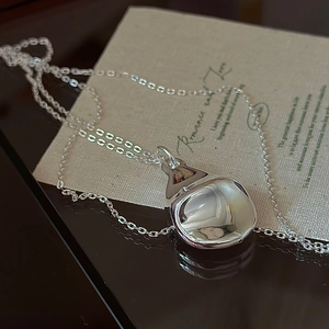 S925 sterling silver hollow teardrop pendant necklace with polished mirror finish on a card
