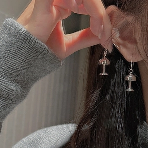 Detailed close-up of S925 silver mushroom stud earrings worn on model ear with mirror finish
