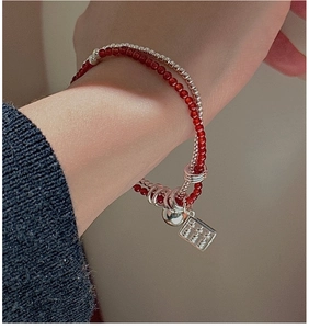 Close-up of double-layer S925 silver beaded bracelet with red agate and Ping An tag