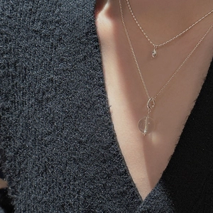 Detail of S925 sterling silver layered necklace with yellow crystal and water drop pendant