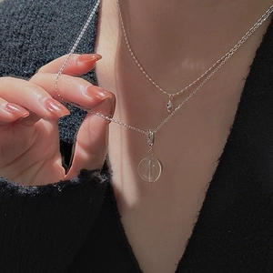 Close-up of S925 silver double-layer necklace with a clear crystal bead on black fabric