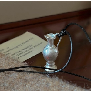 Detailed macro view of S925 sterling silver mini kettle pendant with retro matte finish