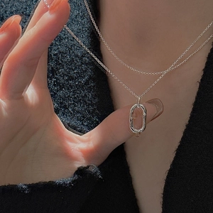 S925 sterling silver double layer necklace with an oval hollow pendant on model