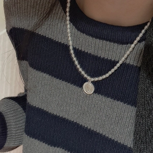 Detail of S925 silver necklace featuring small pearls and a Queen Elizabeth coin pendant