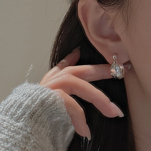 S925 sterling silver hoop earring with vintage star pattern shown on model's ear