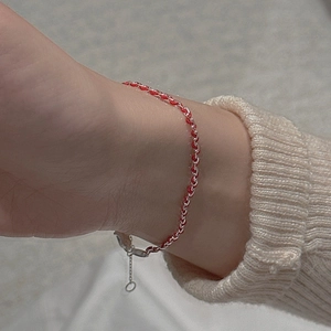 Minimalist S925 sterling silver and red woven rope bracelet on a female model wrist