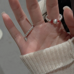 Gros plan de bagues en perles d'argent S925 avec touches d'agate rouge sur la main