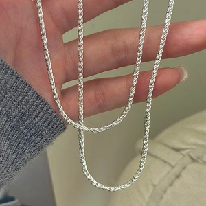 Handheld view of a S925 sterling silver rope chain necklace with a vintage twisted design