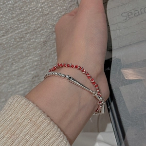 Detail view of red braided rope bracelet with S925 sterling silver beads and cone pendant