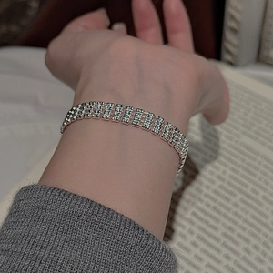 Detailed close-up of multi-layer S925 sterling silver beaded bracelet with sparkling texture
