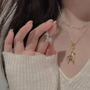 Detail of S925 silver pony pendant with sparkling zircons on elegant cable chain