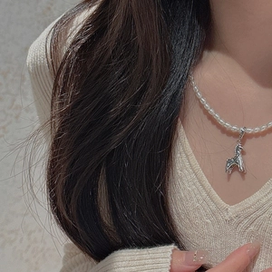 On-neck view of a S925 silver horse pendant on a lustrous freshwater pearl necklace
