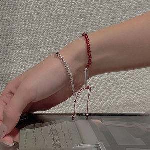 Detail of S925 sterling silver beaded bracelet with red agate and adjustable drawstring